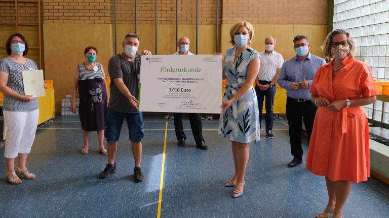 In Anwesenheit der Bundestagsabgeordneten Ursula Groden-Kranich (rechts) übergab Bundesministerin Julia Klöckner die Förderurkunde über 3010 Euro an die Ehrenamtlichen des Brotkorb in Bingen.